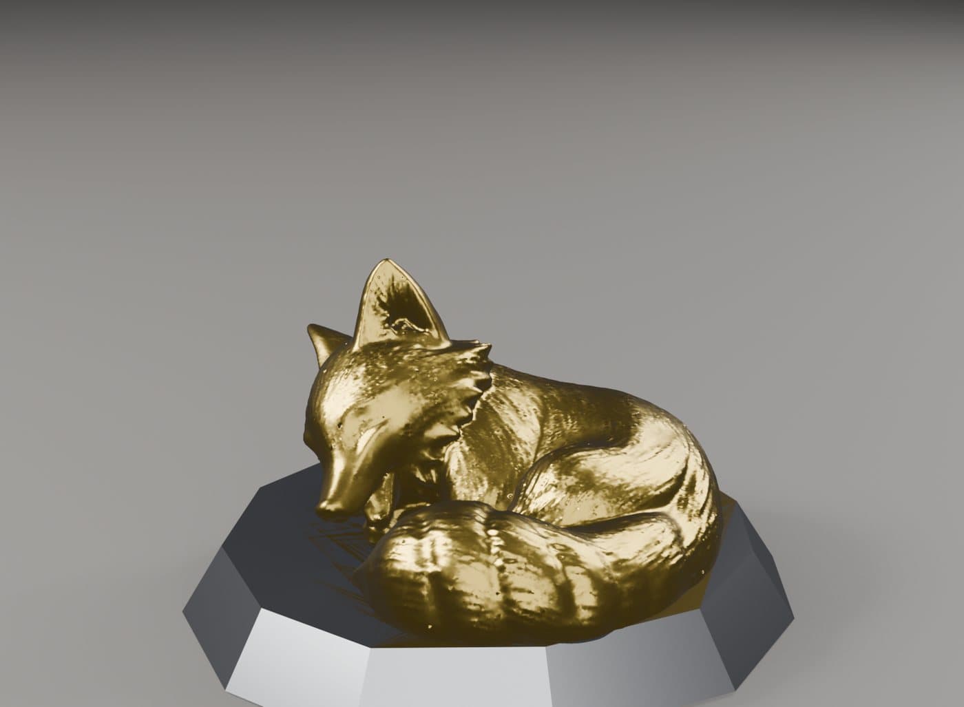 Volpe: Una miniatura acciambellata, oro su una base nera sfaccettata.